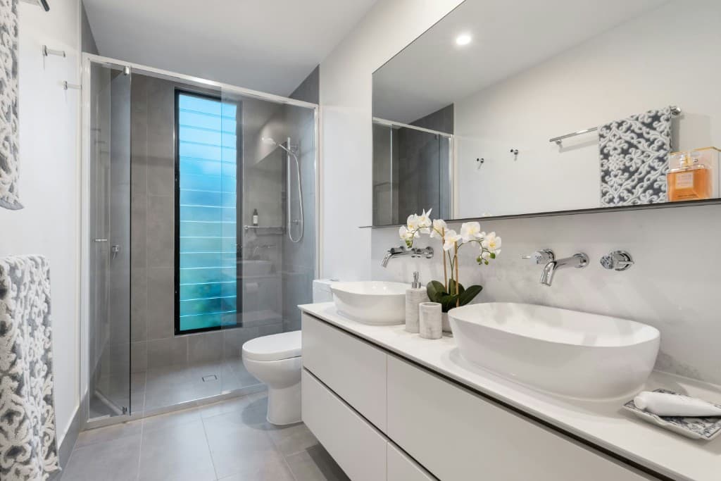Designer bathroom with double vanity, walk-in shower, and premium finishes — Vilano Ikoyi